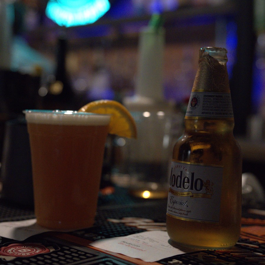 A cold draft beer and a Modelo on the bar