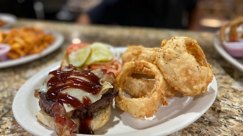 Harry's burger with applewood bacon, pepper jack and BBQ sauce, served with onion rings